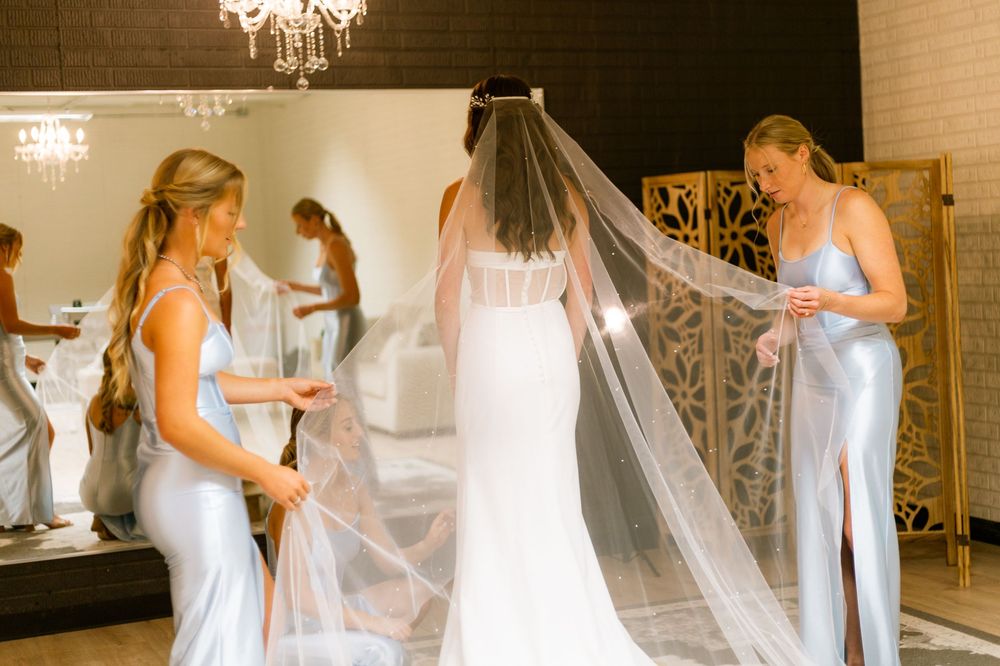 A sequence of wedding preparation moments showing white dresses and veils in an elegant venue with chandelier lighting.