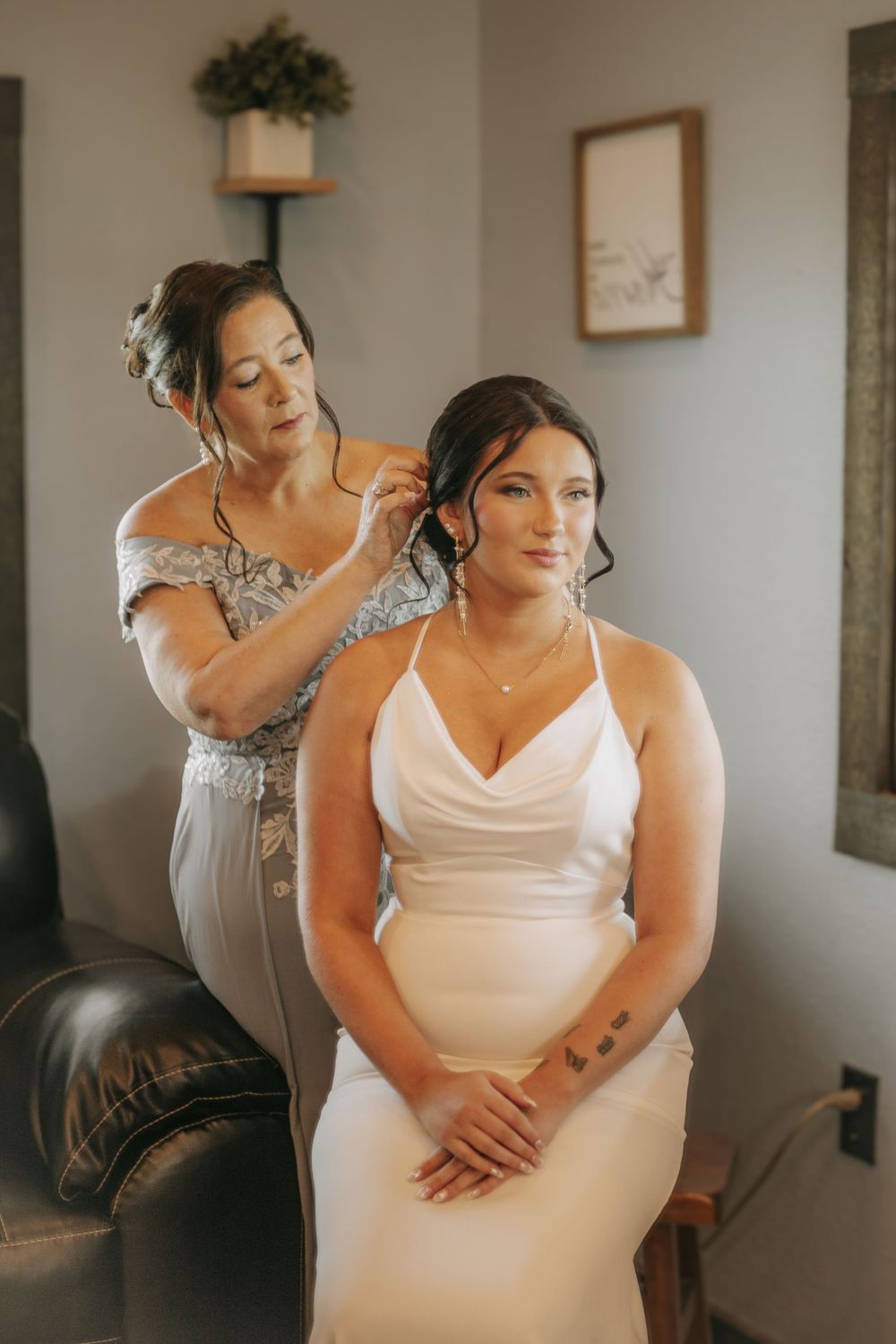 Wedding preparation scene showing final touches being made in an elegant indoor setting.