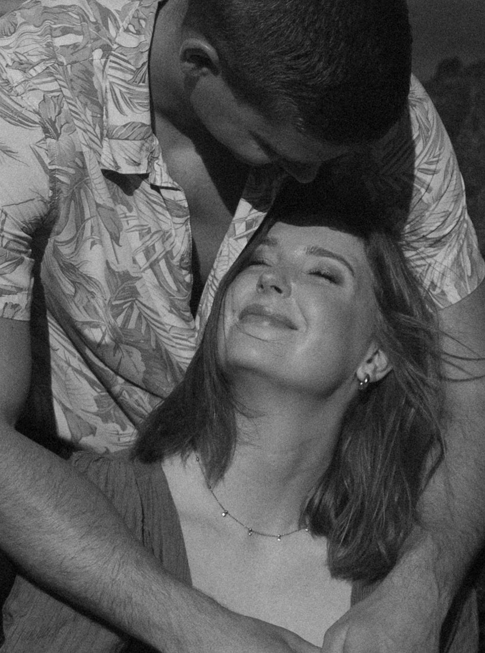 A romantic black and white photo of a couple sharing an intimate moment together.
