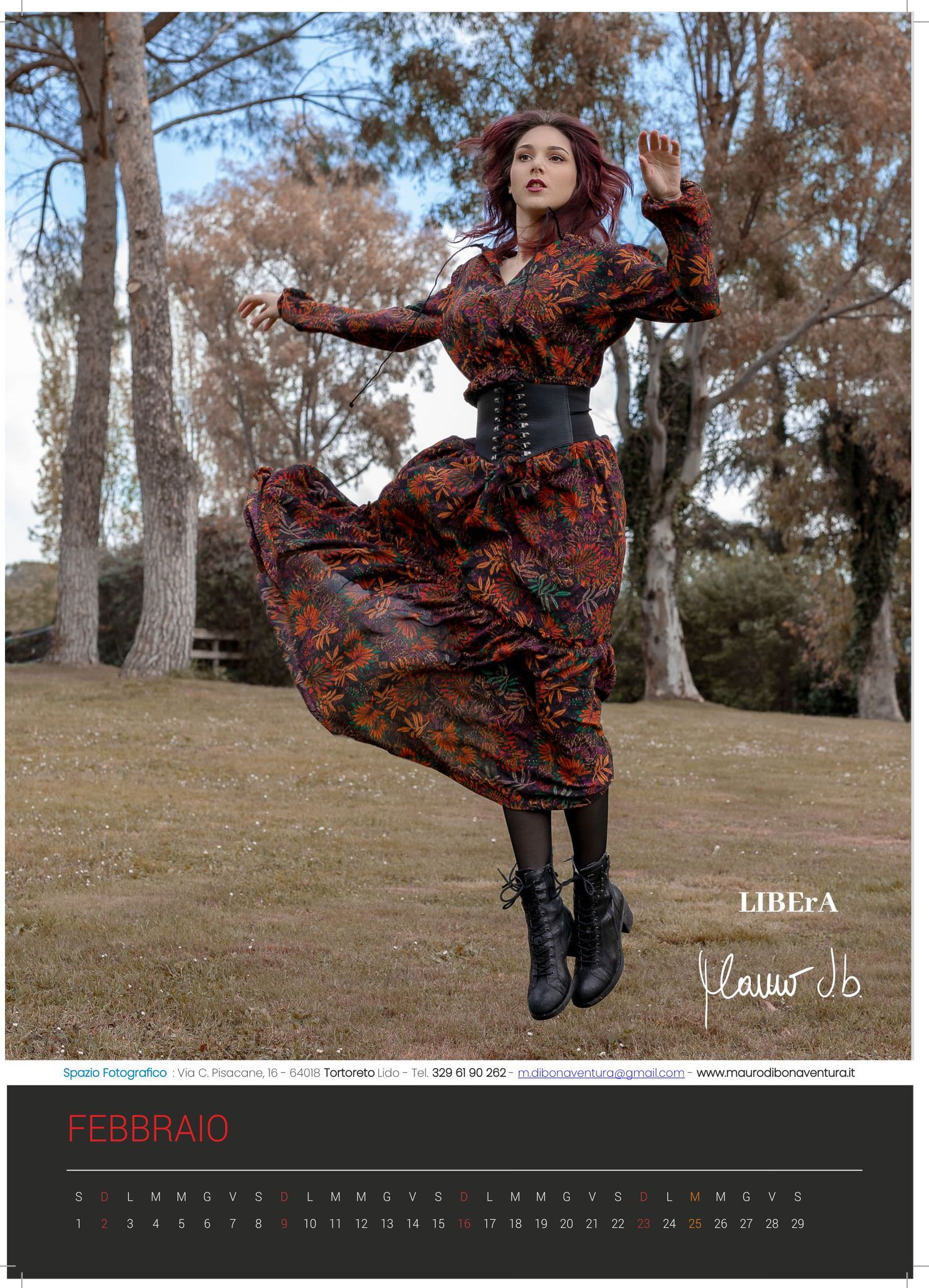 Calendar image showing person in flowing patterned dress jumping in autumn woodland setting.