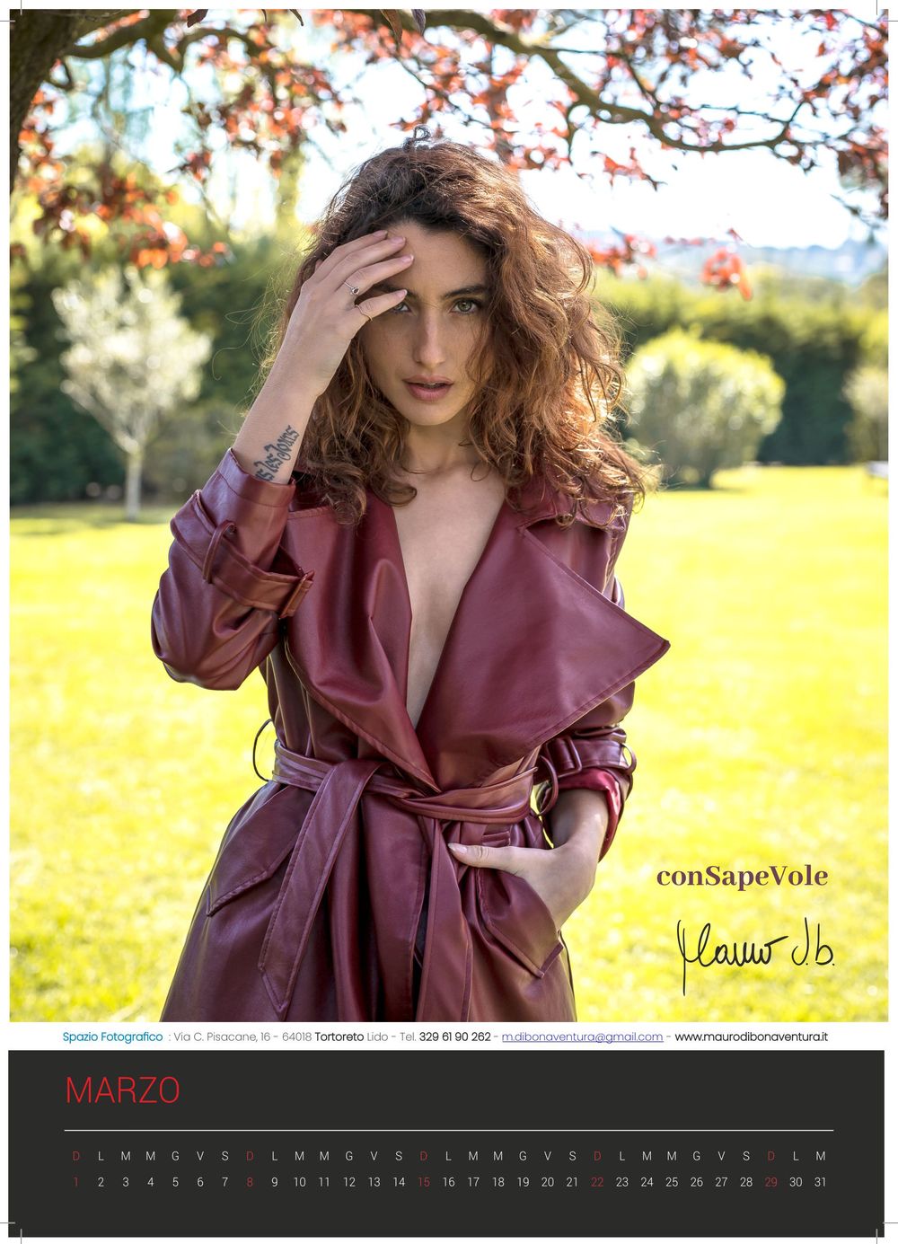 March calendar page showing outdoor portrait in burgundy trench coat.