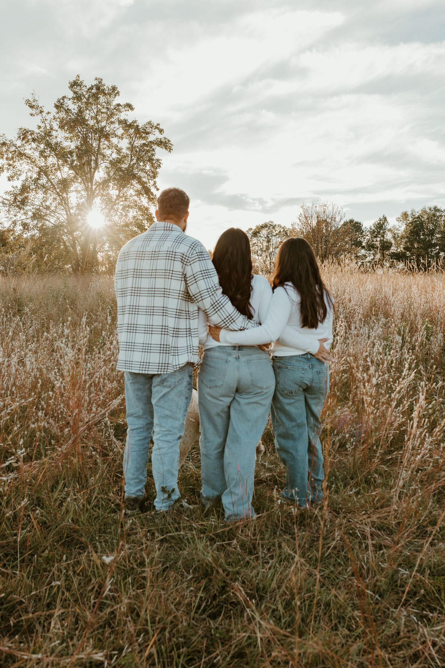 Spartanburg SC Family photographer taking photos in field while boy runs around pretending to be an airplane