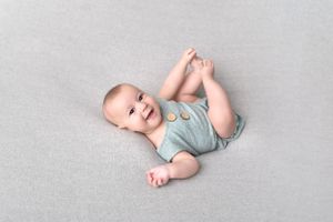 Sweet baby poses on light gray background showing happy expressions and movements.