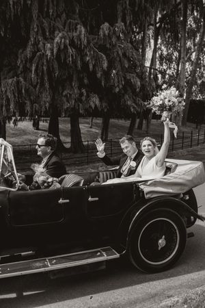 A vintage black and white photo sequence showing people waving from a classic convertible car driving past.