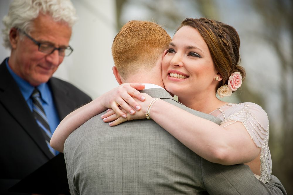 Joyful wedding celebration moment captured during an outdoor ceremony embrace.