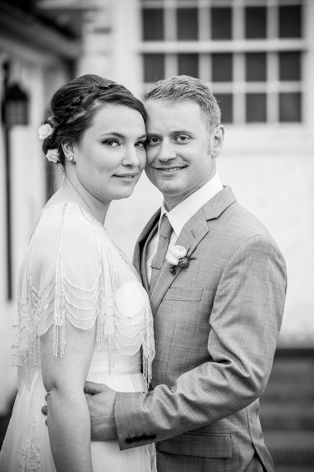 Romantic black and white wedding portraits showing tender moments between newlyweds in formal attire.
