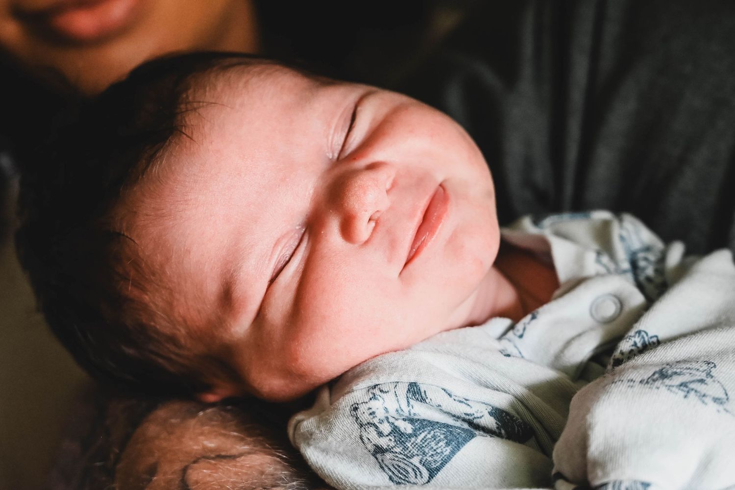 Newborn baby boy smiling at session in Troy, NY