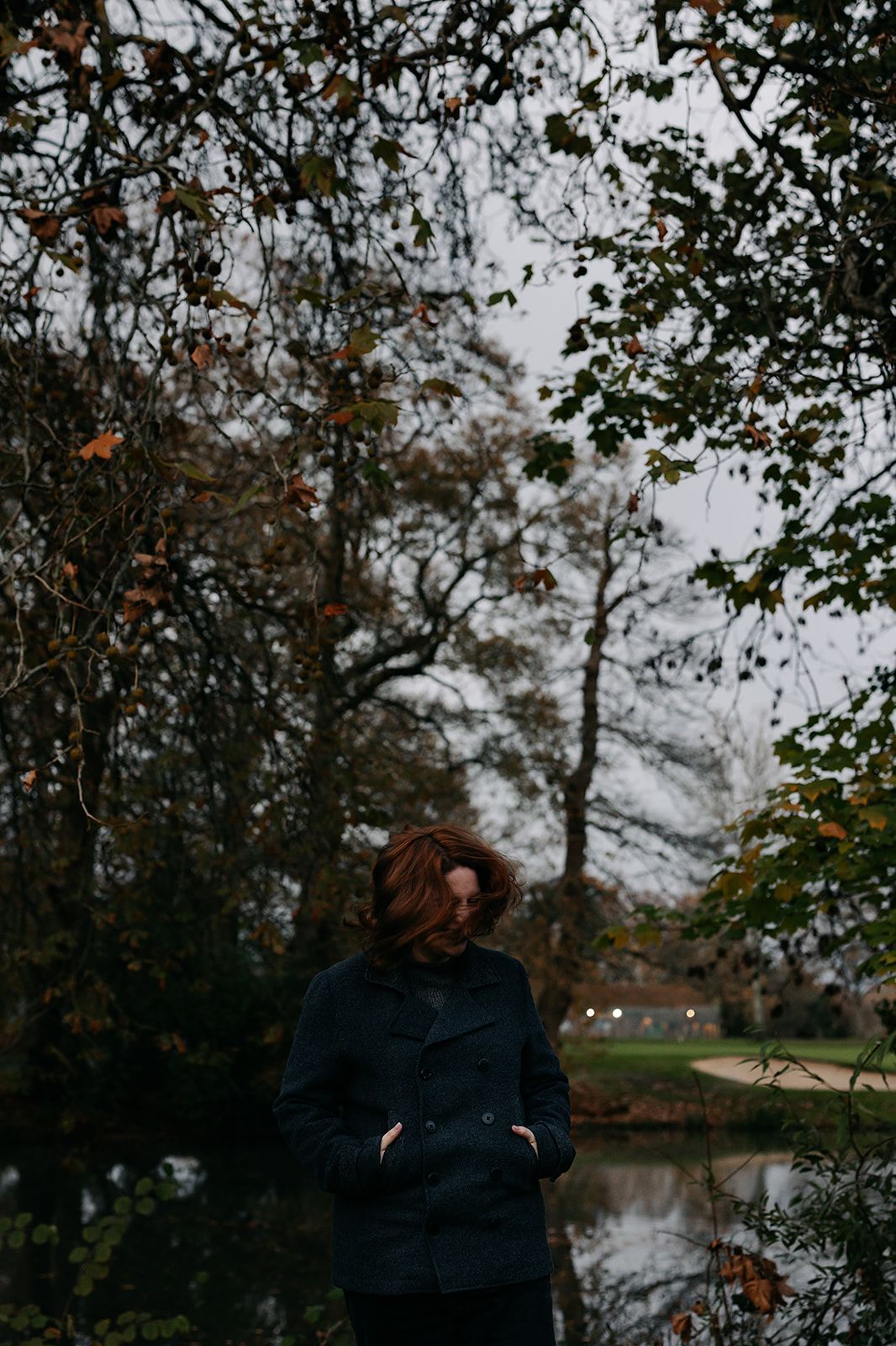 Moody autumn landscape photos showing trees reflected in still water under an overcast sky. fiction and fantasy writer