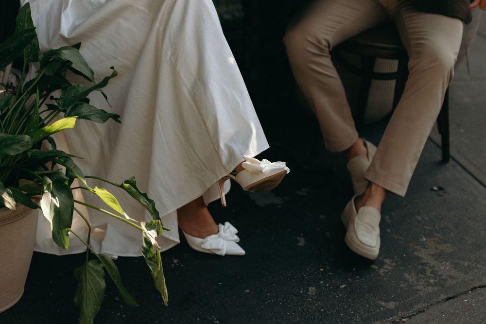 A sequence of wedding photos showing close-up details of white dress fabric, hands, and floral arrangements.