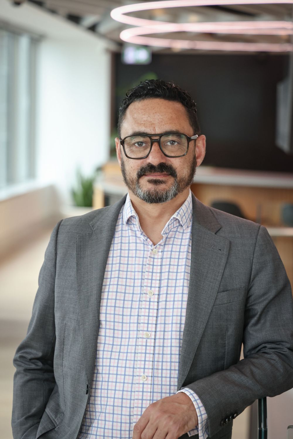 Carlos Michel in an engaging headshot/portrait taken at Suncorp HQ, Auckland by photographer, actress,  artist Amanda Billing.