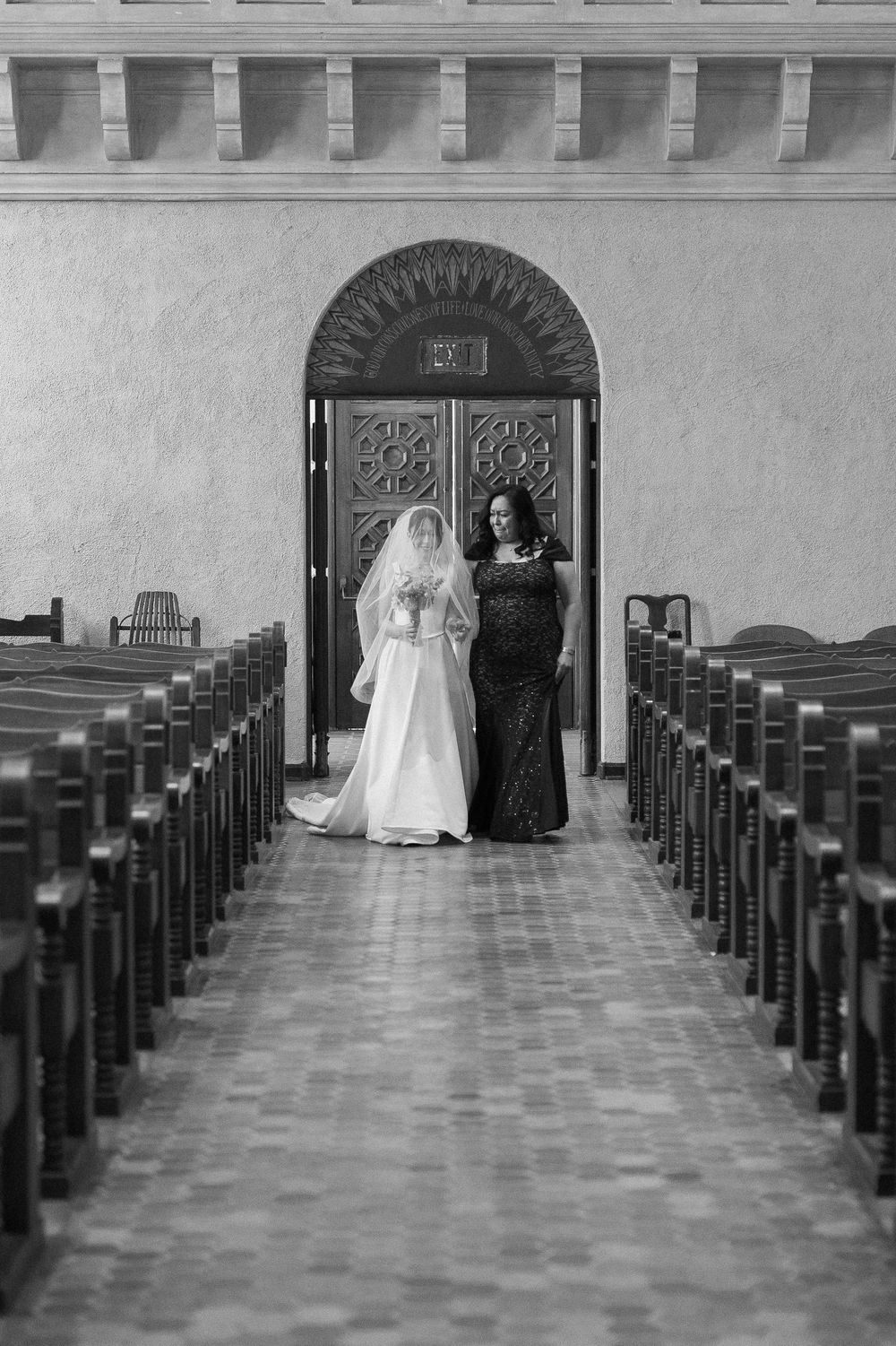 Santa Barbara photographer captures the bride walking down the aisle escorted by her mother in an emotional moment.