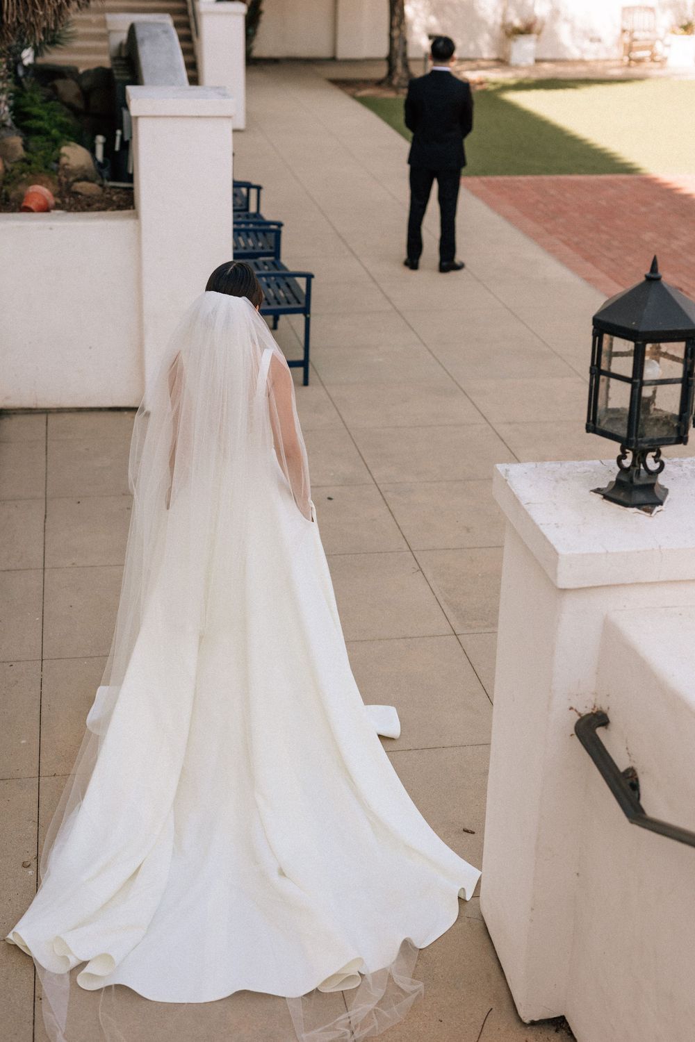 A candid photo of a bride approaching her groom for a first touch before their wedding at the Unitarian Society of Santa Barbara.
