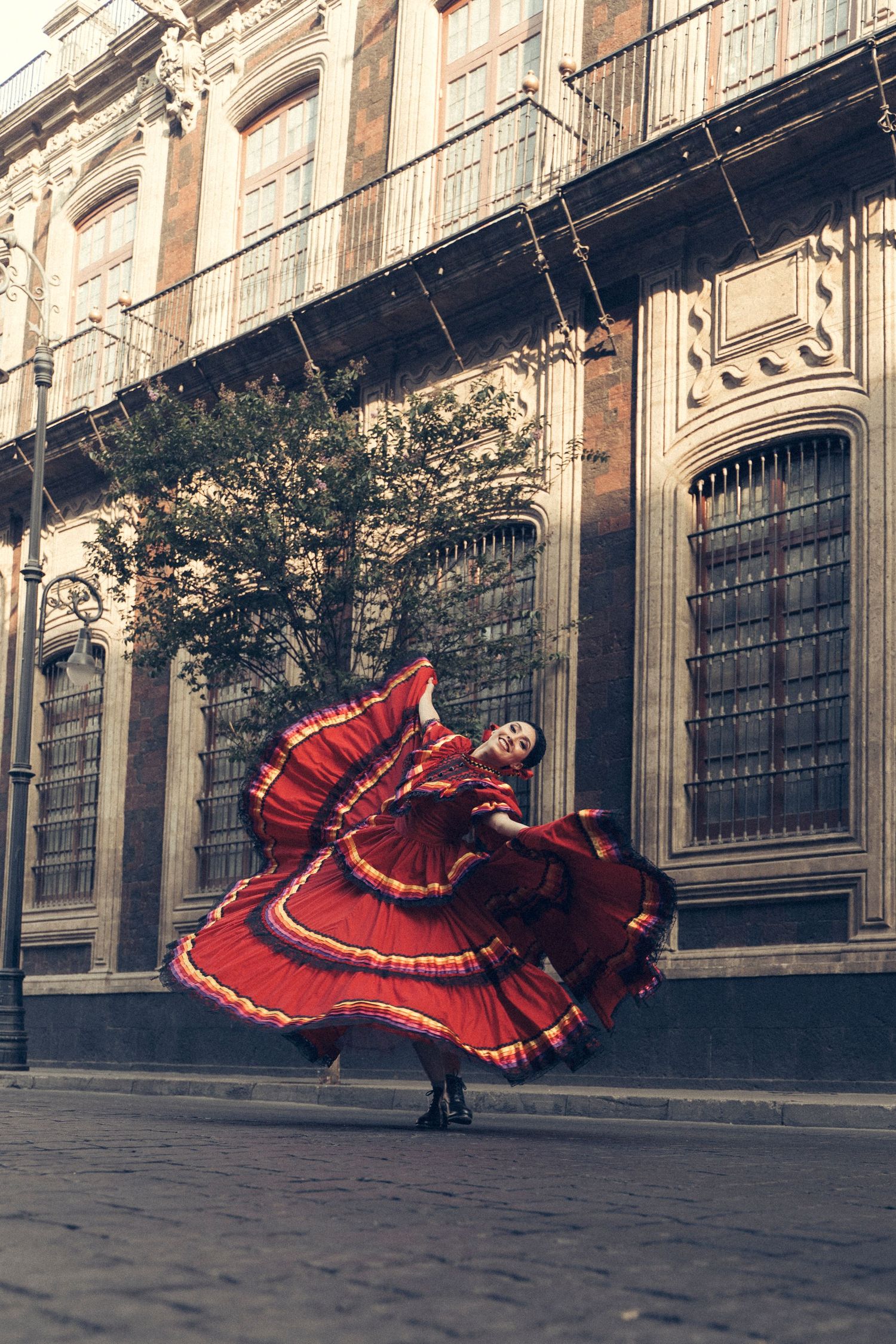 Ballet Folklórico dancer captured in motion on the streets of Mexico City during professional photoshoot