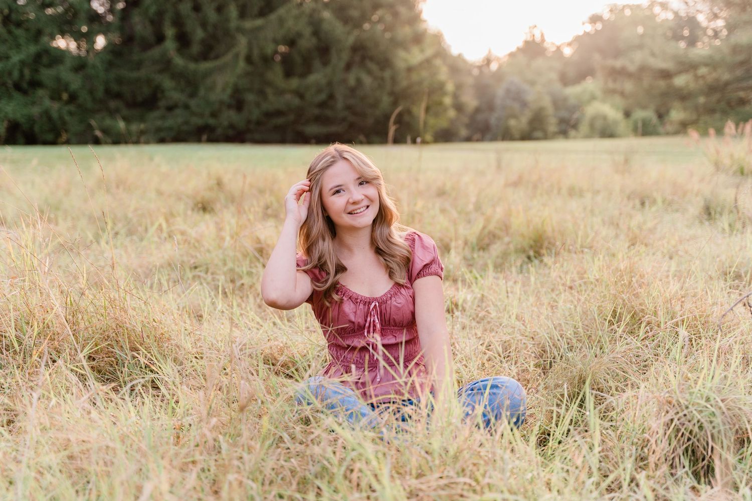 Springfield High School senior poses in golden grassy fields at Toledo Botanical Garden for her fall senior session.