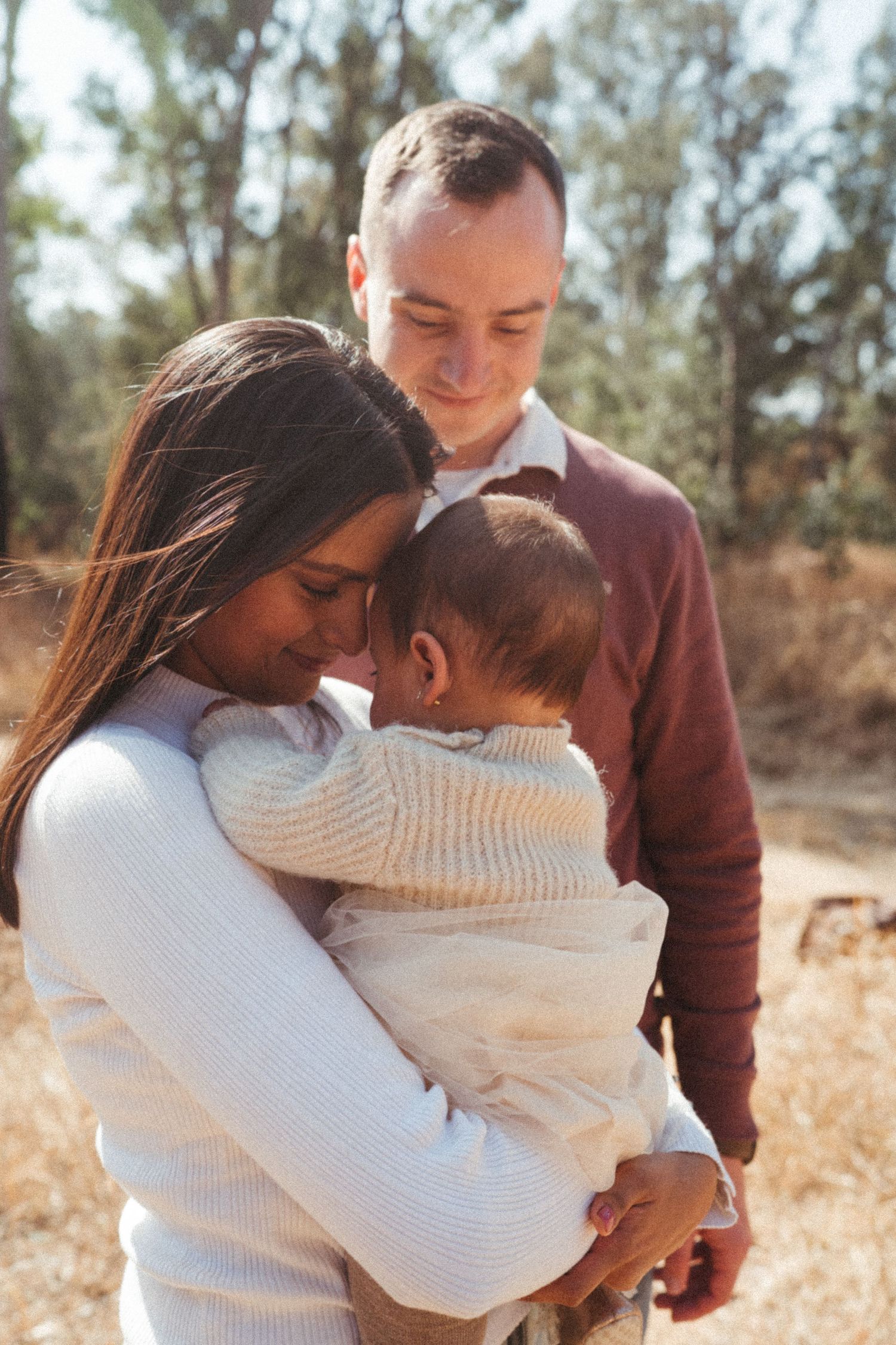 Loving family moments captured in sequence against a backdrop of autumn trees.