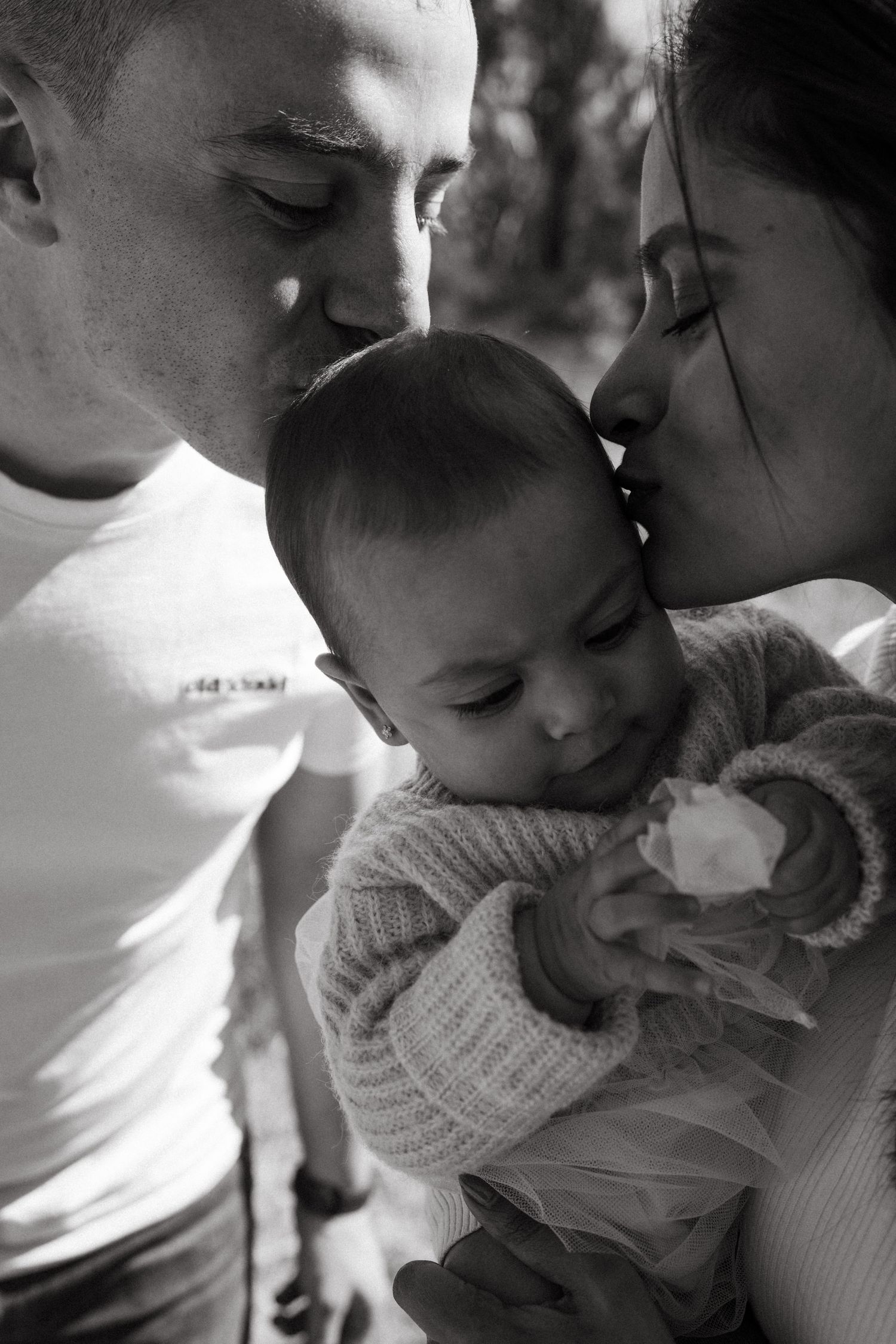Intimate black and white close-ups of family affection and connection.