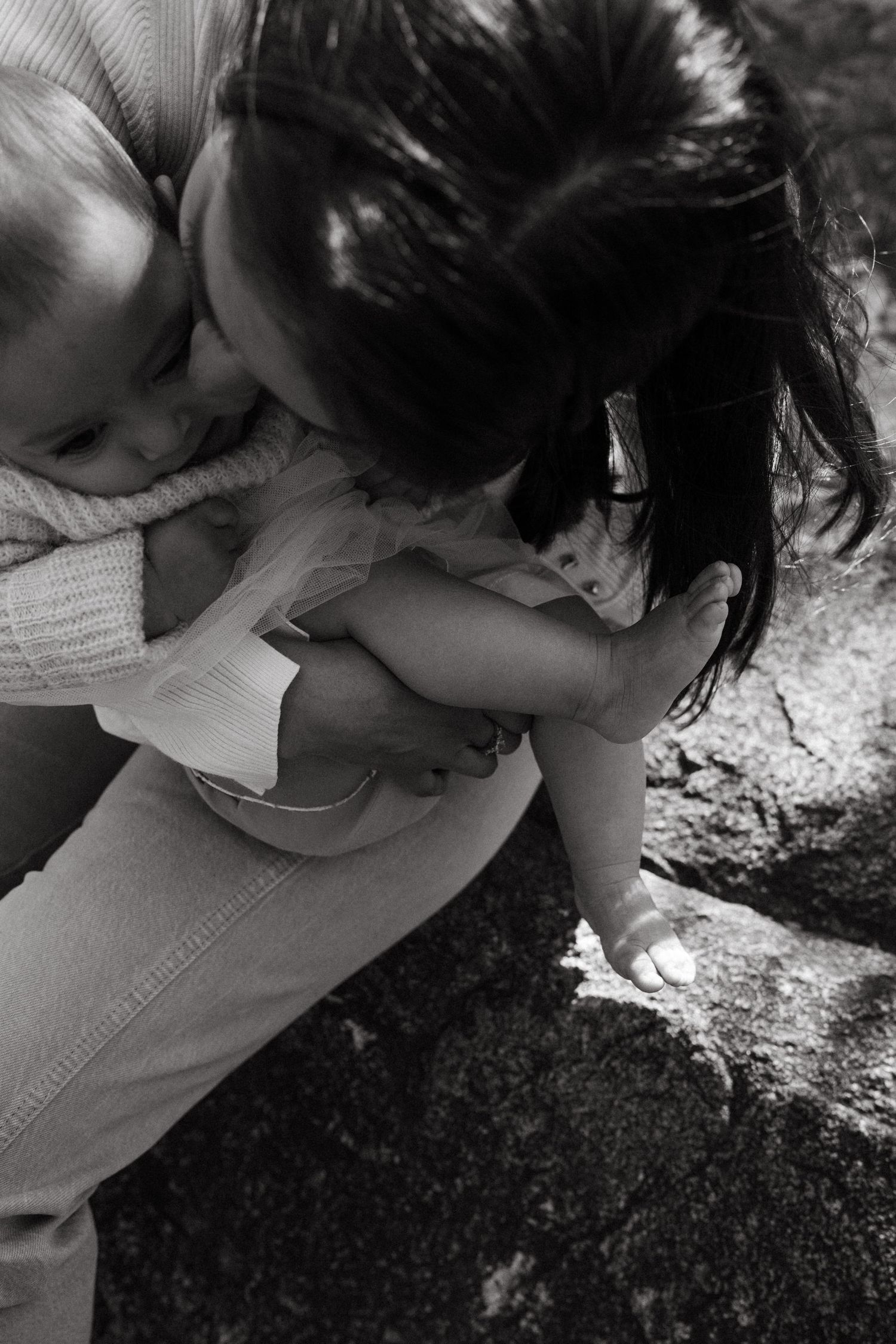 Intimate black and white close-up shots capturing gentle family interactions.