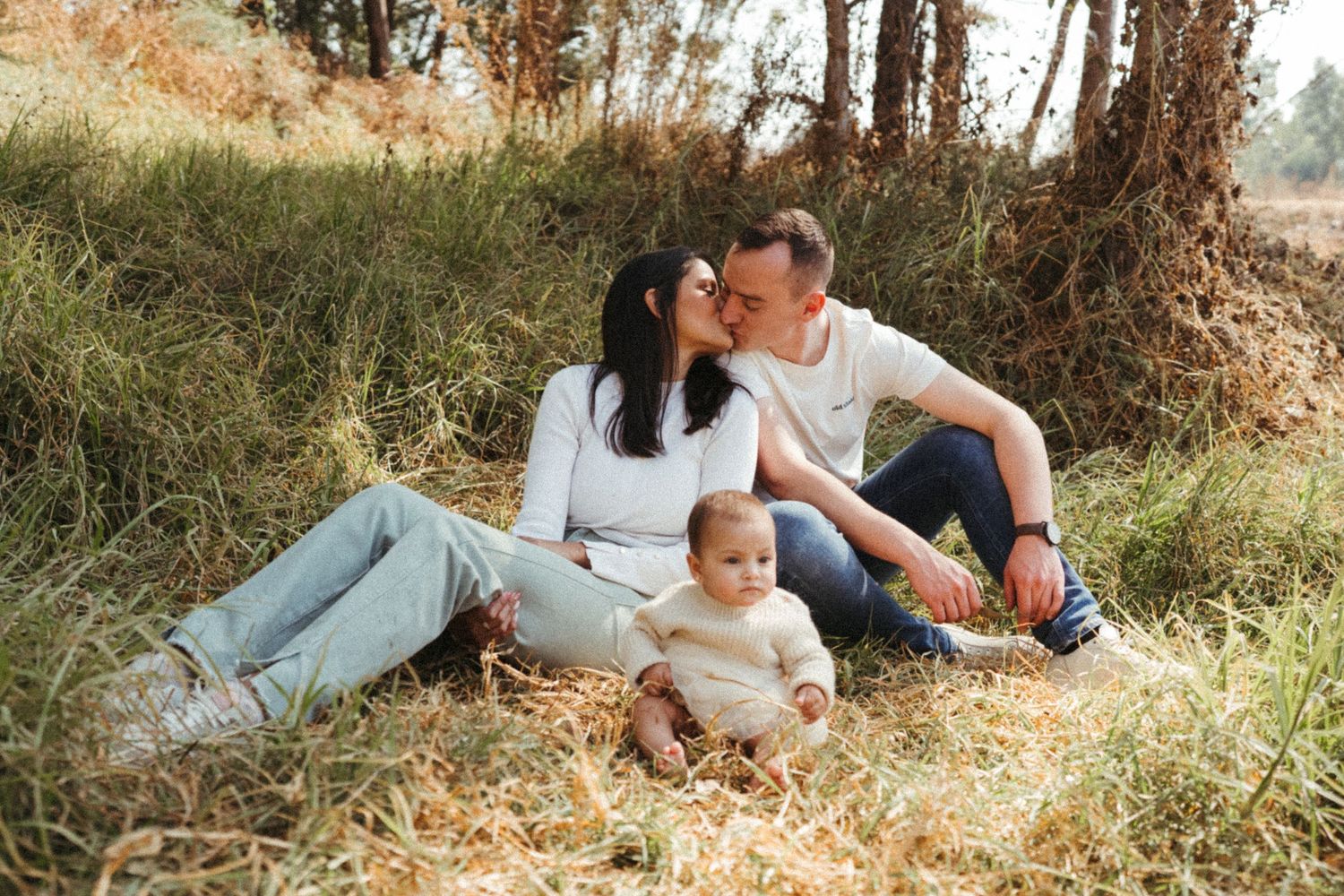 Panoramic outdoor family photo series capturing intimate moments in a natural setting.