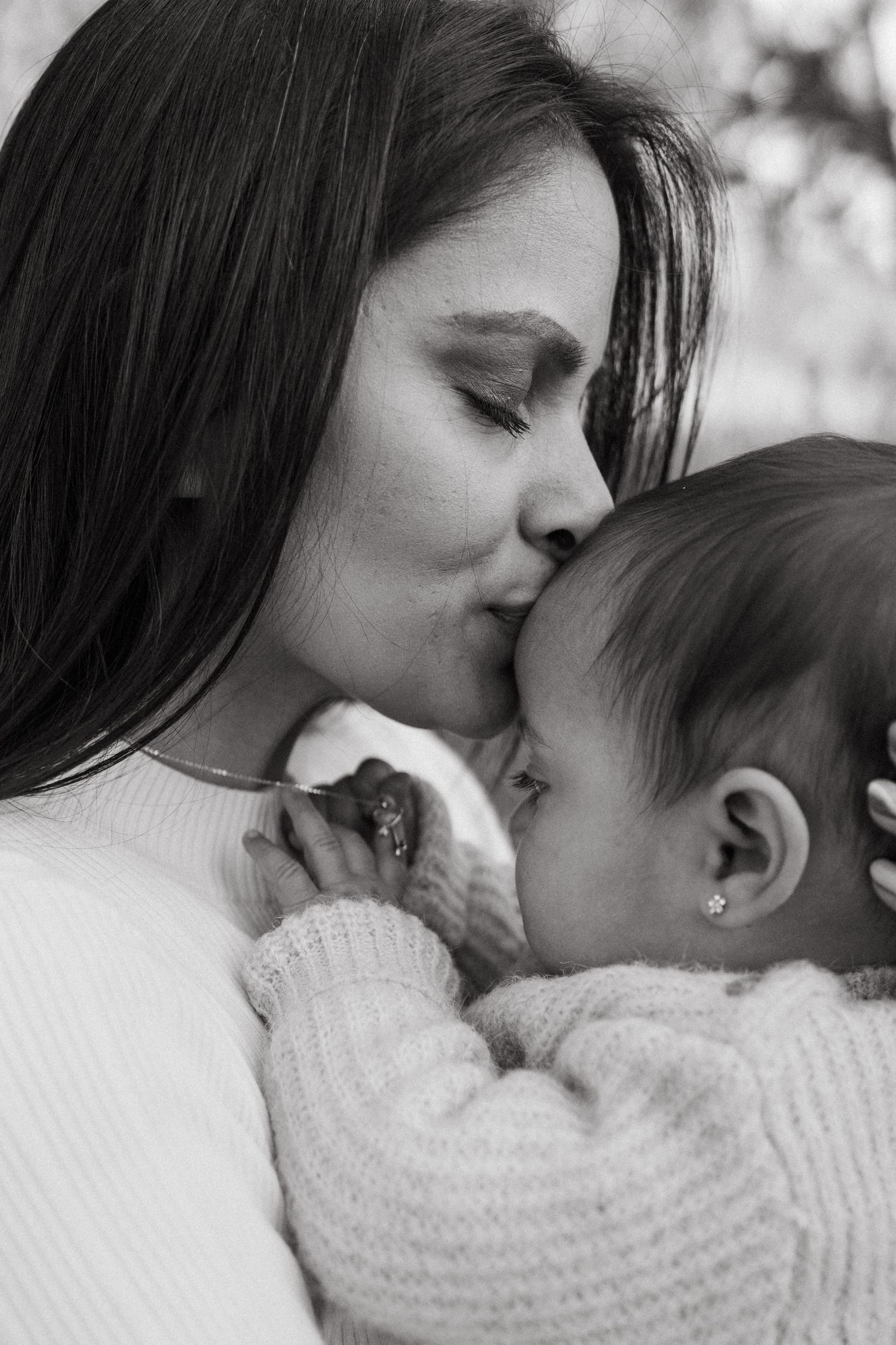 Black and white intimate portraits showing gentle moments between parent and child.