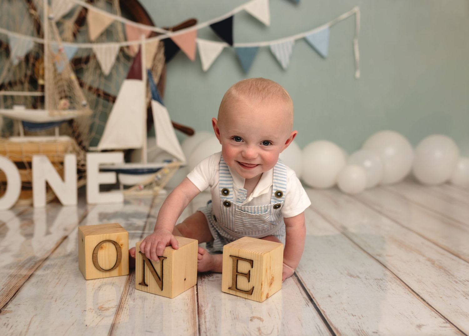 Baby boy turns one with a nautical-themed cake smash session, captured by Somerset Portraits, a Charlottesville newborn photographer.