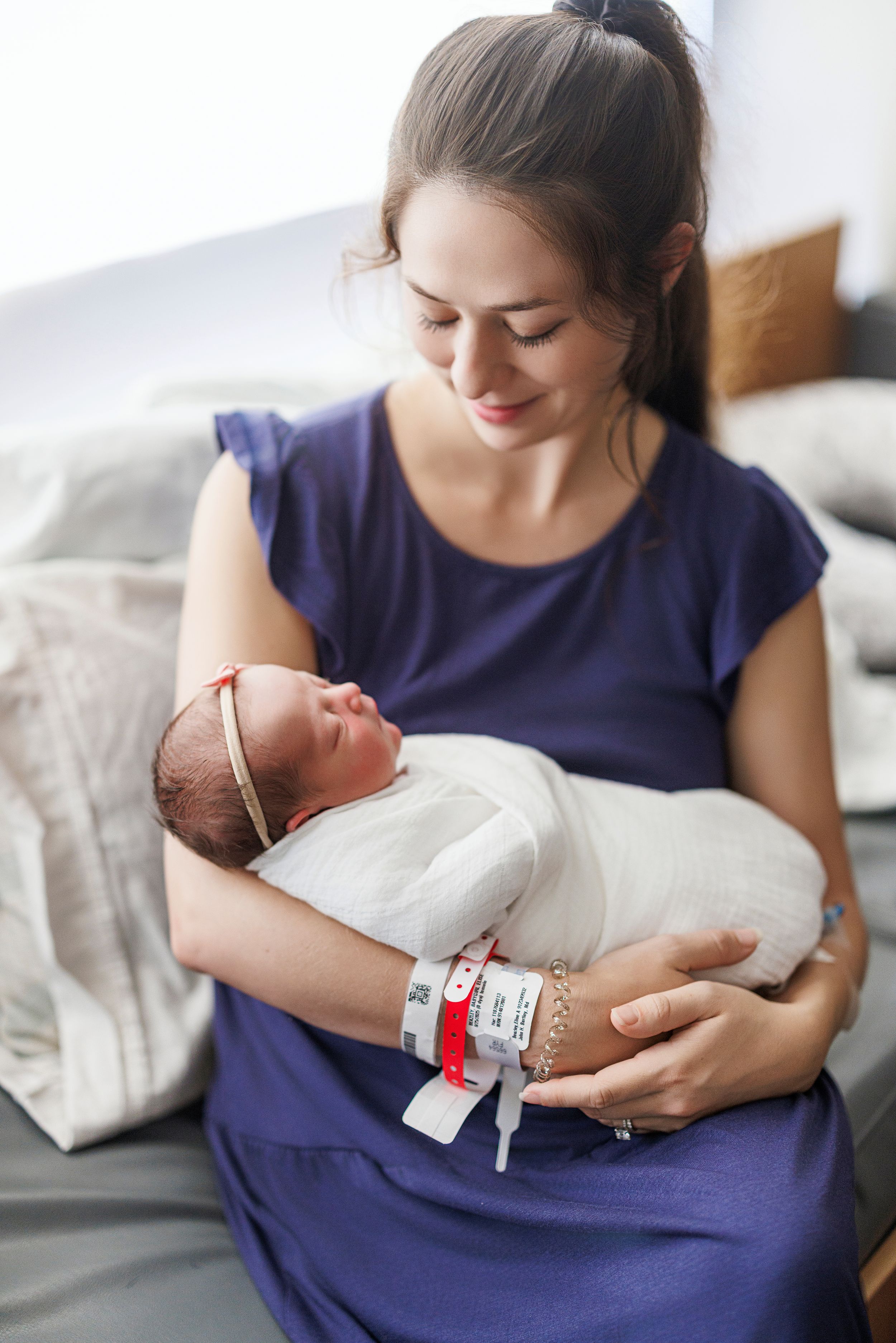 A tender moment captured in a series of photos showing a newborn baby being cradled in a white blanket.