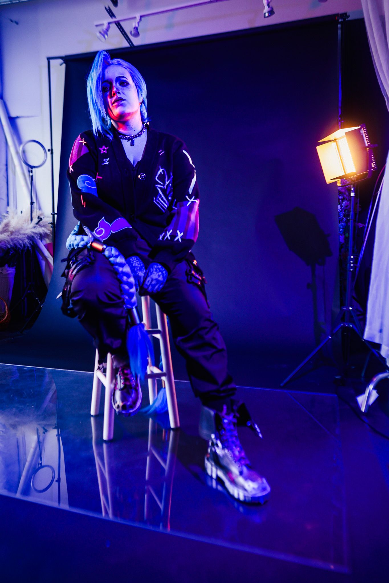 A series of dramatic purple-lit photos showing someone sitting on stairs in dark clothing with moody lighting effects.
