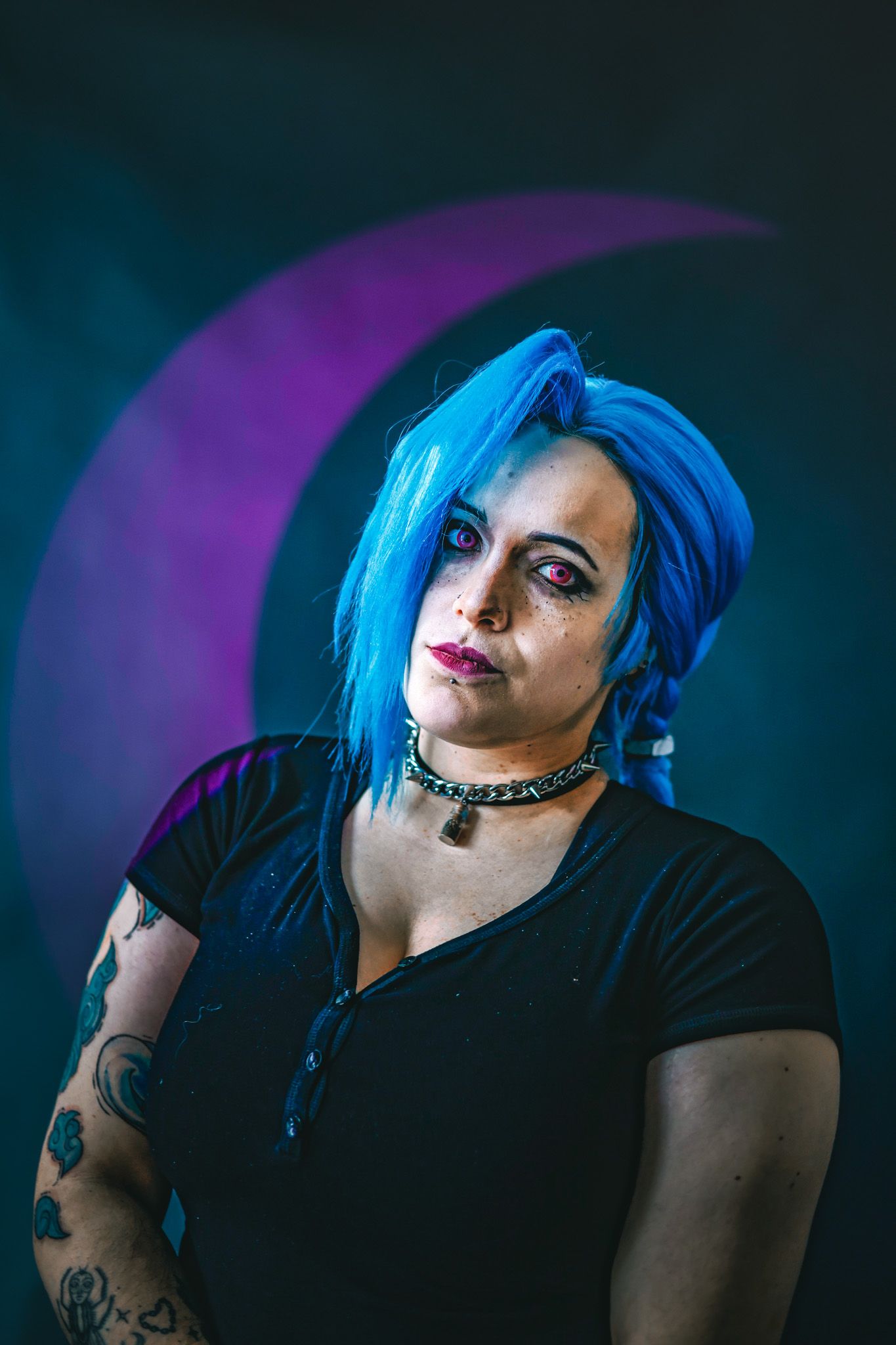 Dramatic portrait series with blue hair and dark clothing against purple and teal lighting effects in studio setting.