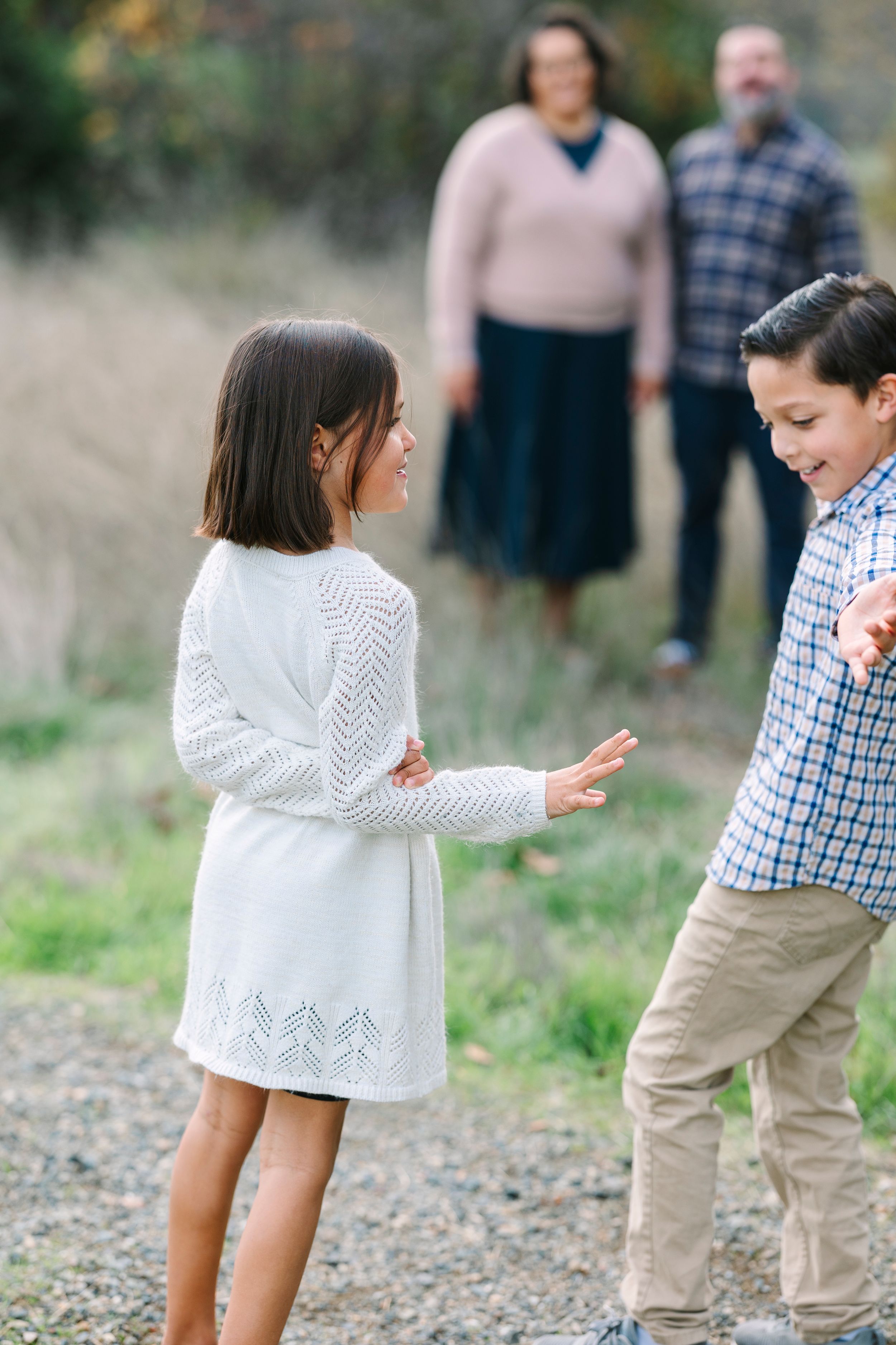 Family members interacting playfully in a natural outdoor setting.