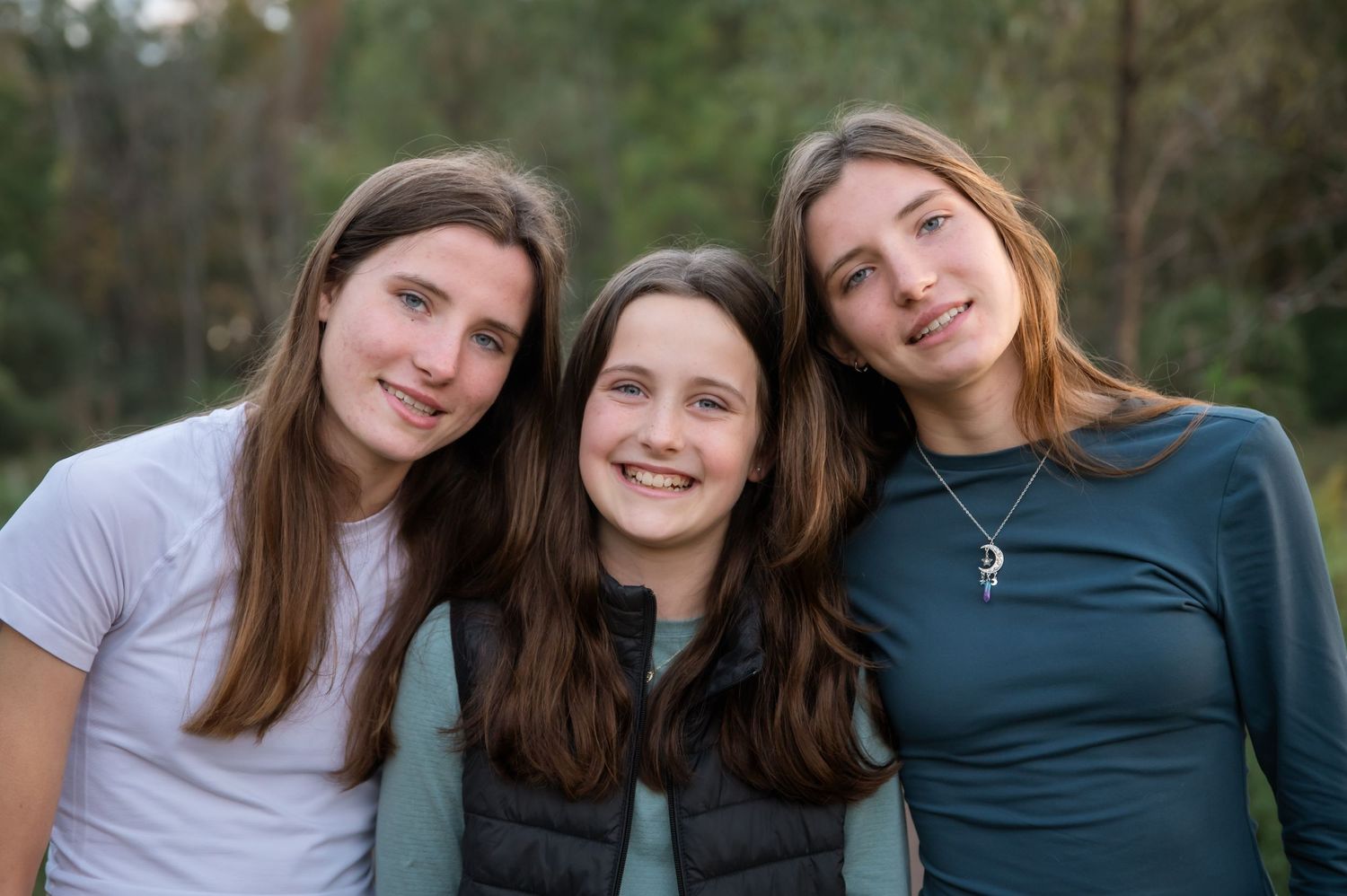 A series of four connected outdoor portrait photos showing a group posing together against a natural background.