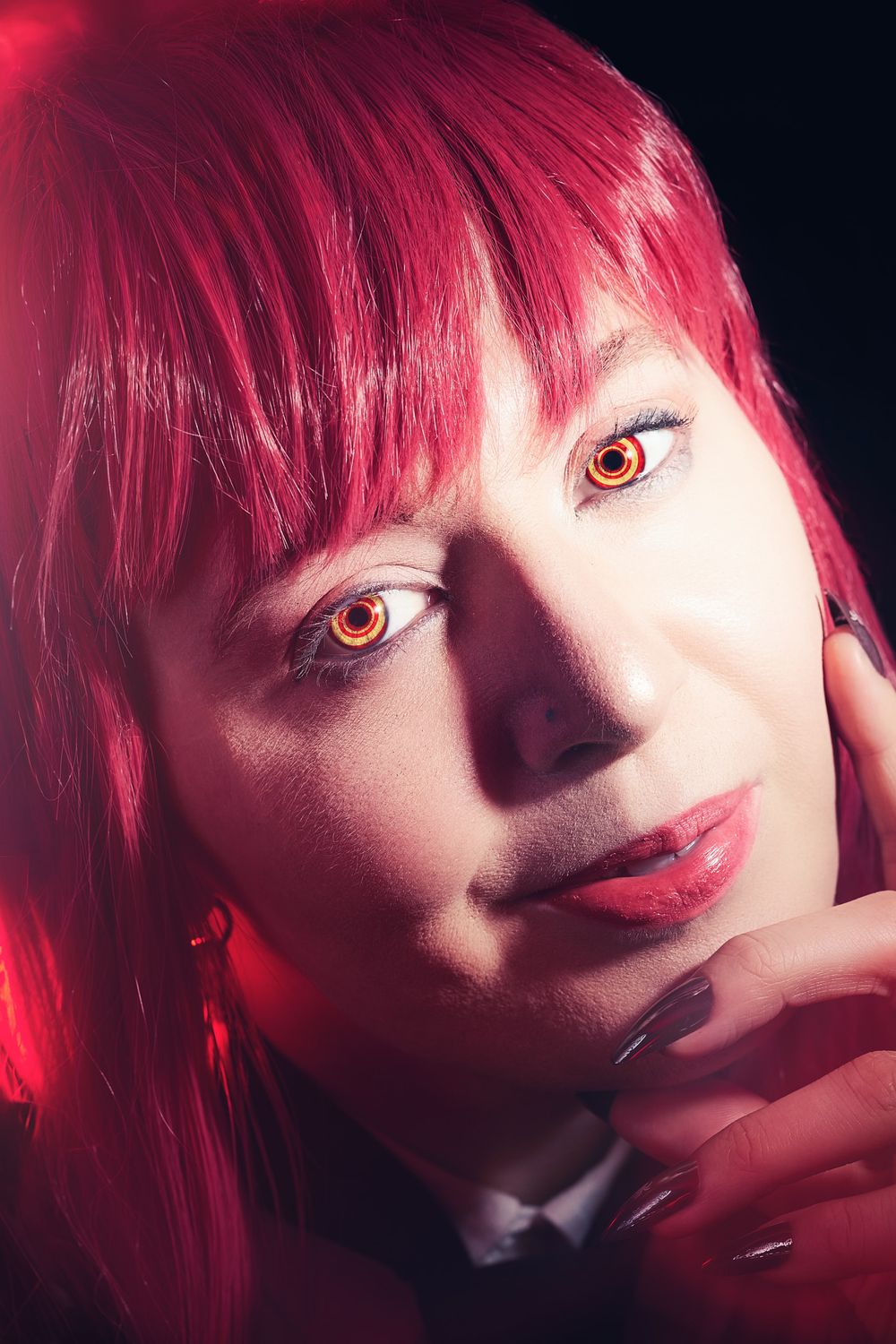 Artistic portrait series showing dramatic lighting on bright magenta hair against a dark background.