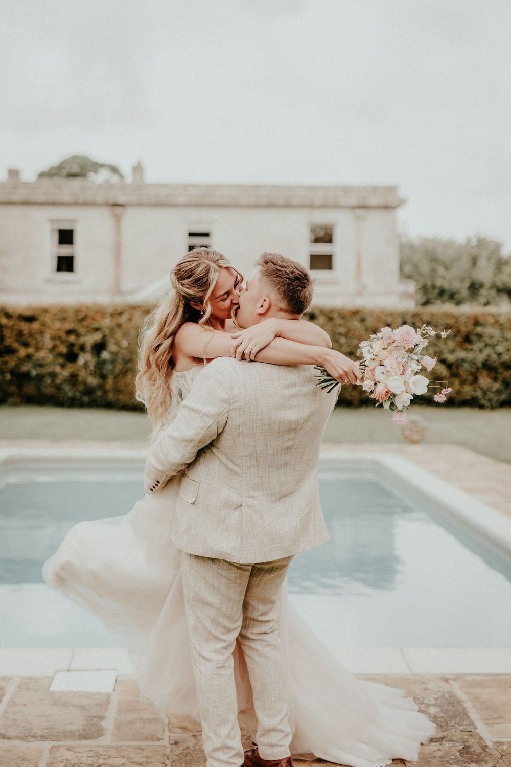 A romantic wedding sequence showing a couple dancing and embracing by a swimming pool. Cornwall wedding photographer