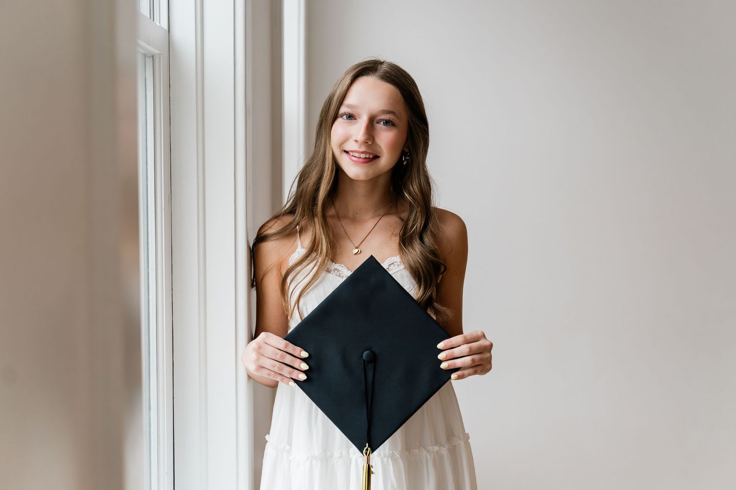 Perrysburg High School Graduate poses with Cap & Gown during photo session.