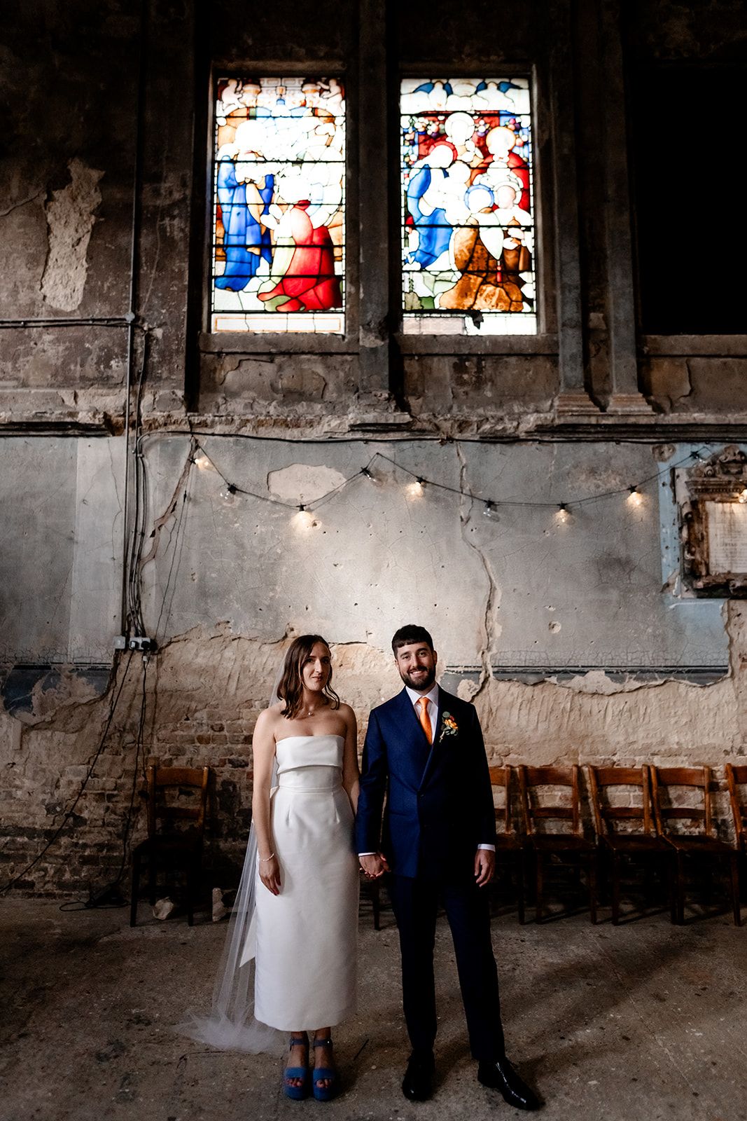 Bride and groom standing in a London Chapel.