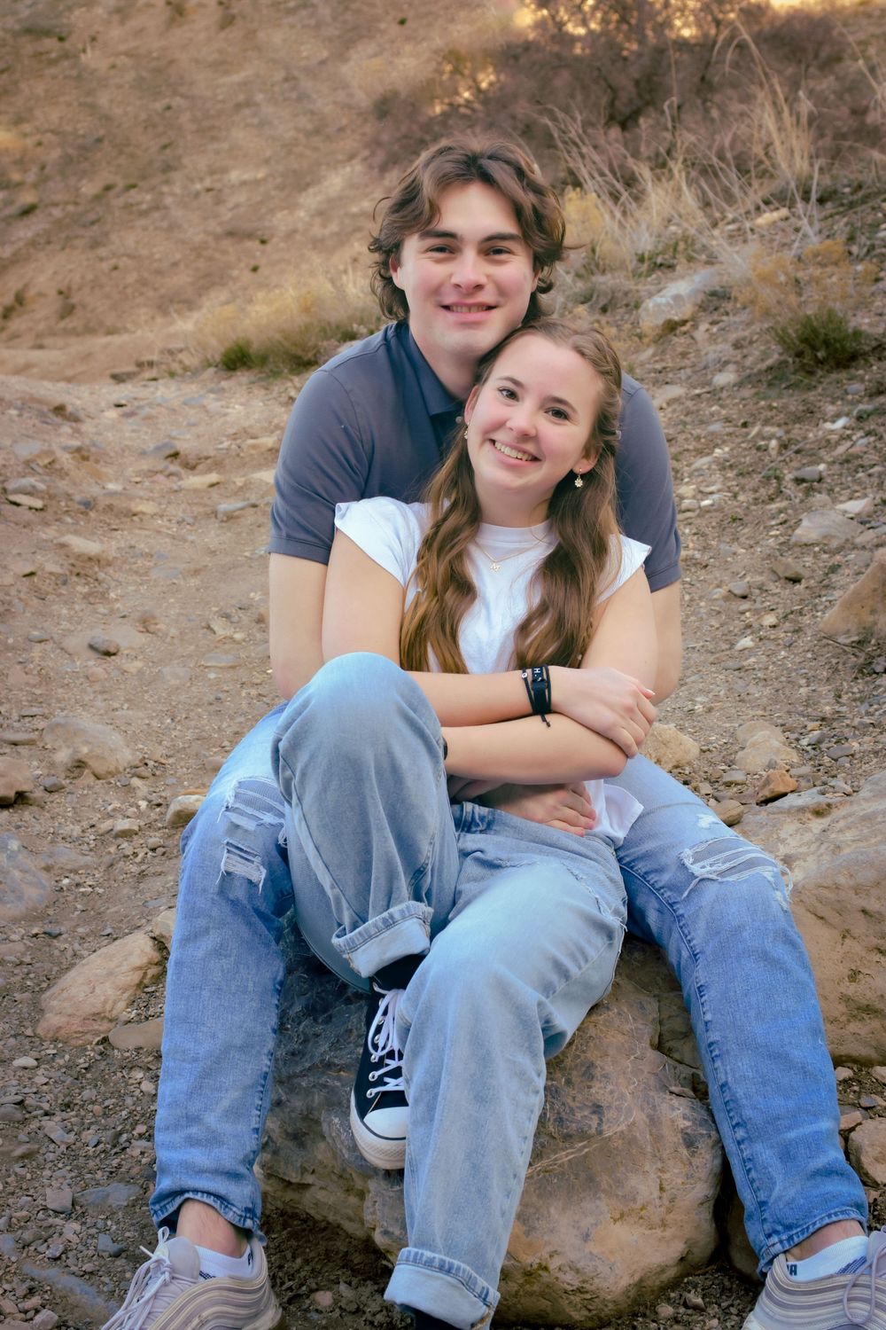 Couple sitting in a bear hug in Provo, Utah.