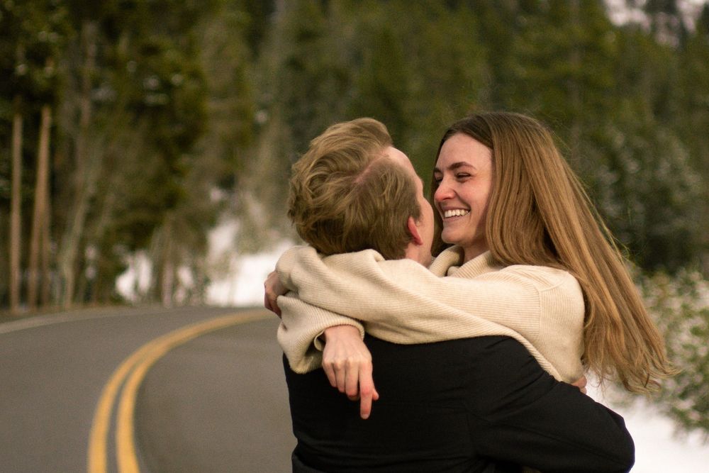 Couple hugs and smiles in street in Salt Lake City, Utah.