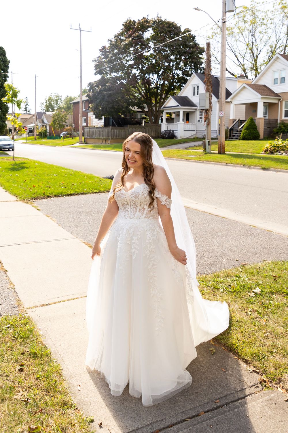 bride showing off her dress outside