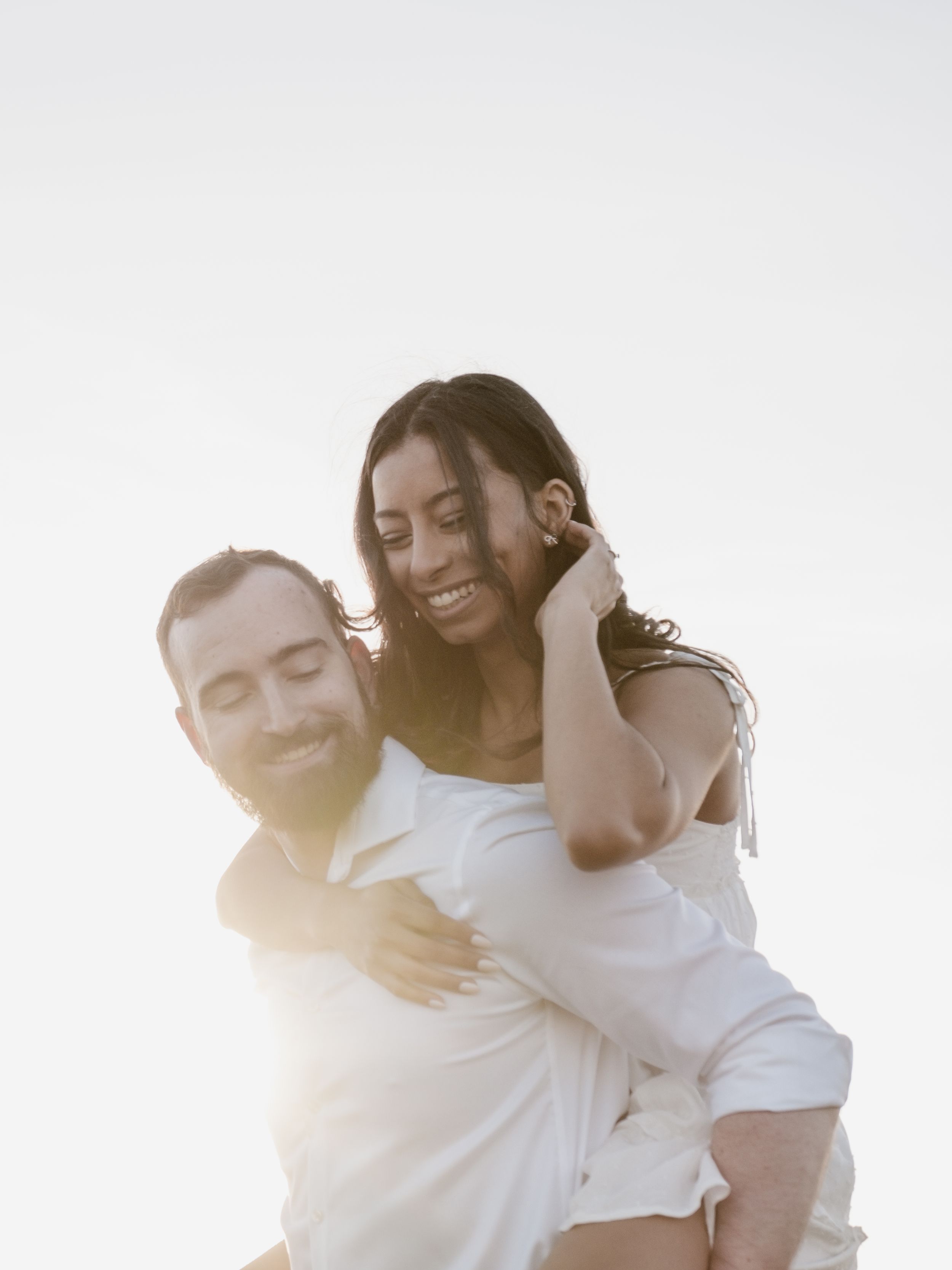 engaged couple piggyback.