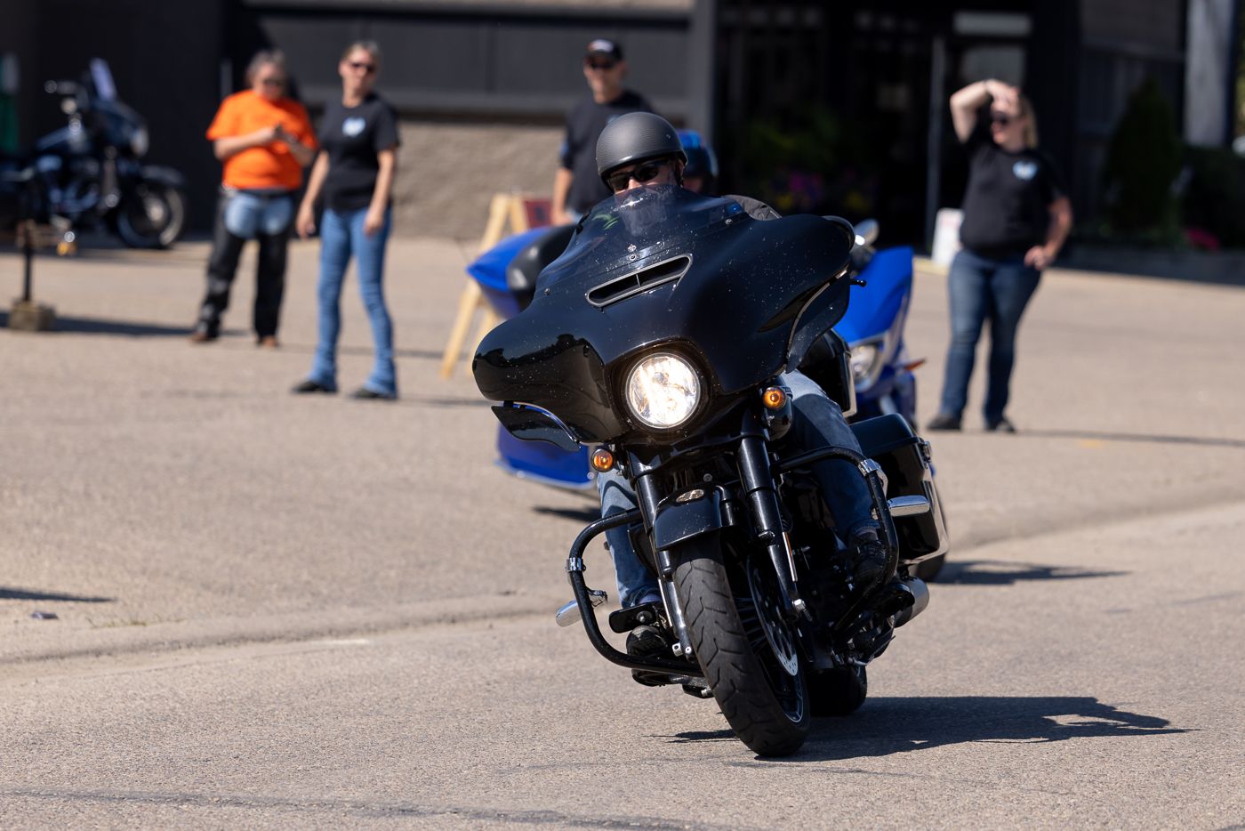 Custom motorcycles parked in a row at a daytime motorcycle meet or show.