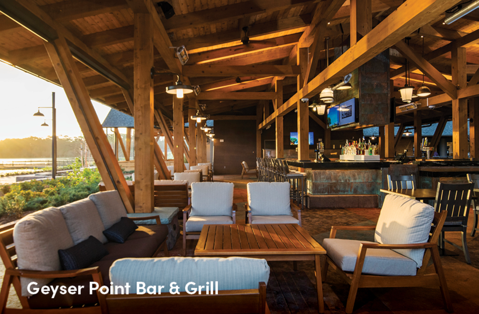 Panoramic view of Geyser Point Bar & Grill's spacious dining area with exposed wooden beams and stone accents.