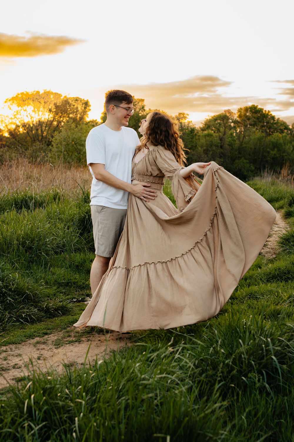 A romantic sunset photoshoot with a flowing maxi dress in a golden field.