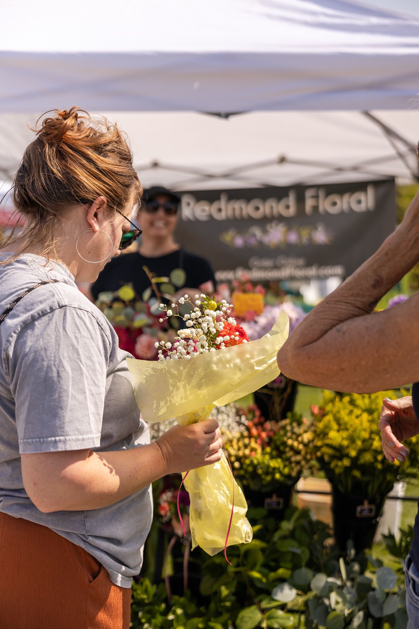 eastside women's day out wellness event in Redmond, WA outdoors vendors and attendees buying local fresh flowers