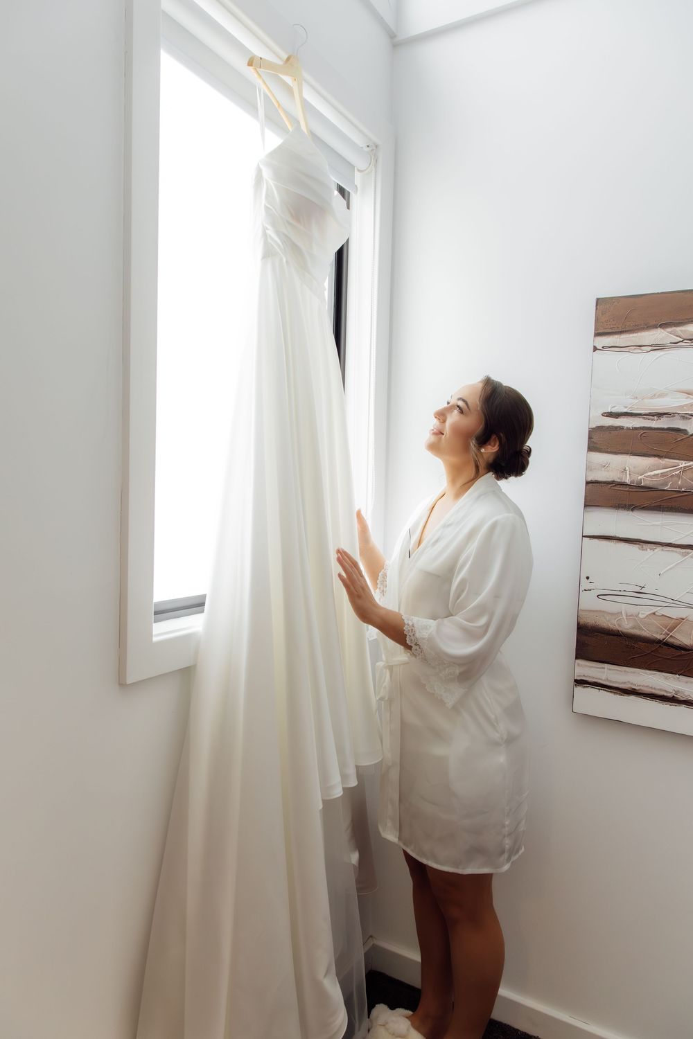 A series of photos showing someone adjusting white curtains in a bright, minimalist interior space.