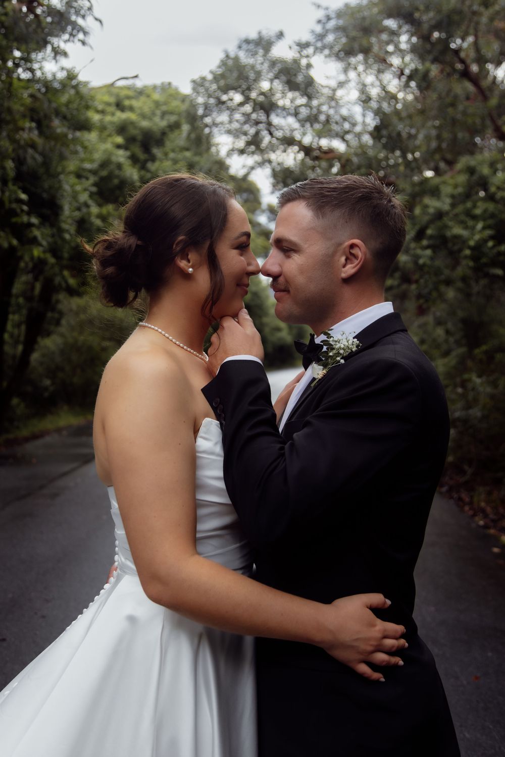 A sequence of romantic wedding photos captured on a tree-lined path outdoors.