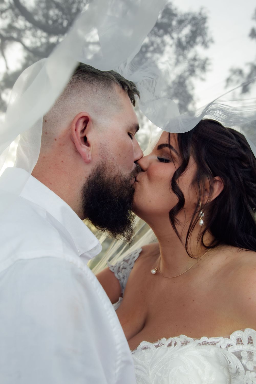 A romantic wedding kiss sequence showing a couple in white sharing tender moments together.