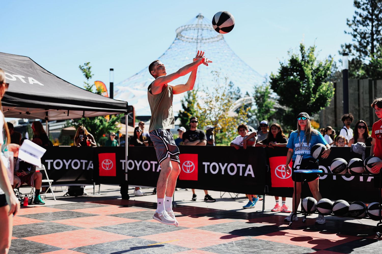 Athletes compete in a basketball tournament with Toyota sponsorship banners visible in the background.