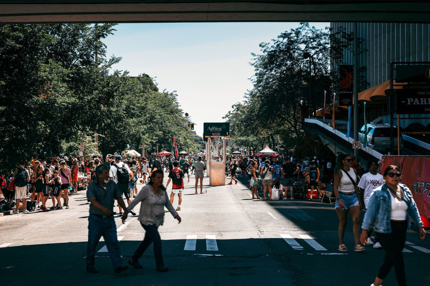 A group of people gathered outdoors on a sunny day participating in a community event or festival.