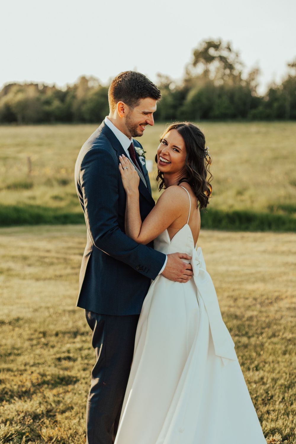 A romantic sunset wedding photo sequence shows a couple embracing in a golden field wearing formal attire.