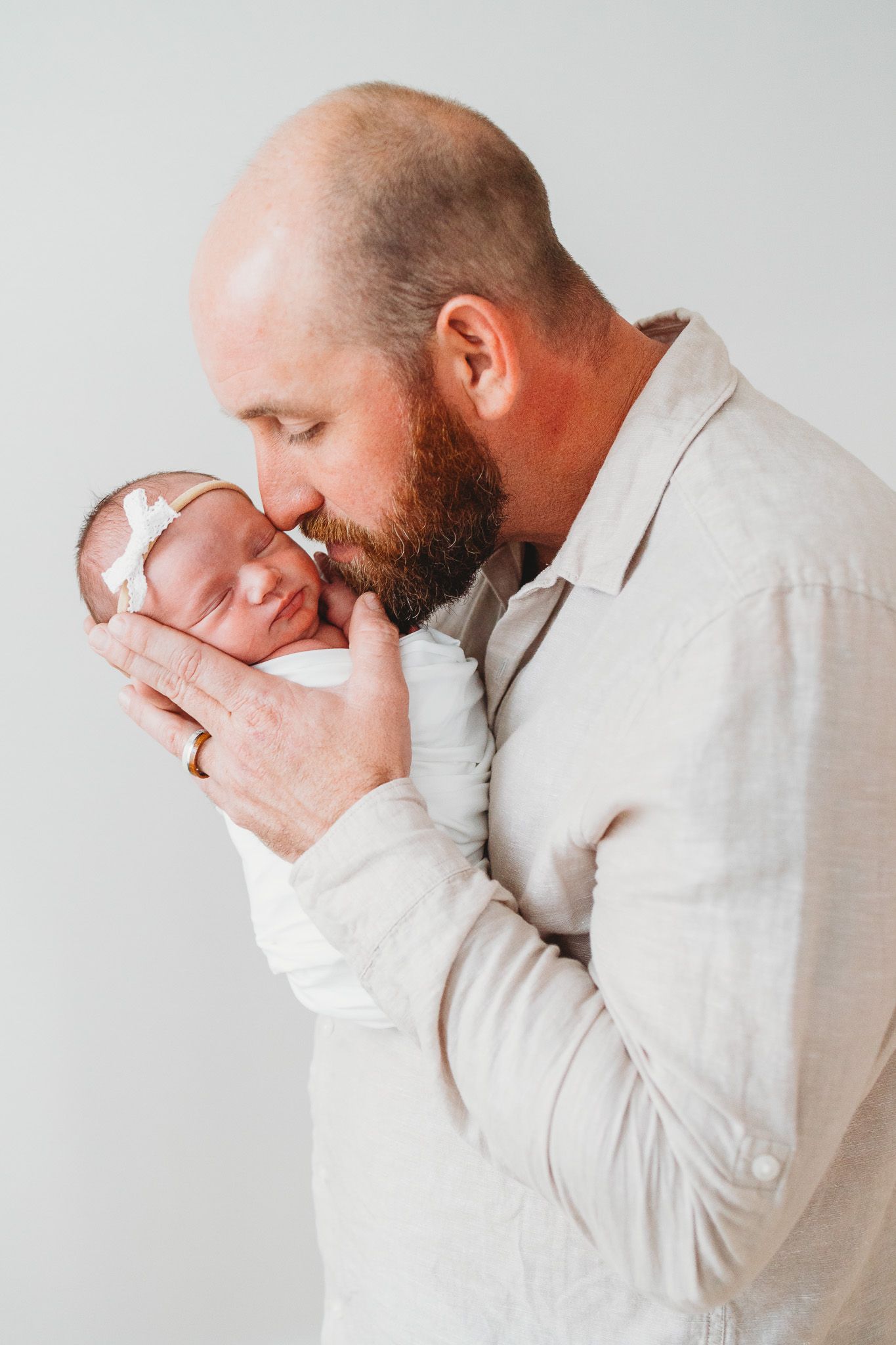 A series of four photos showing a person in white holding their face in their hands with emotional expressions.