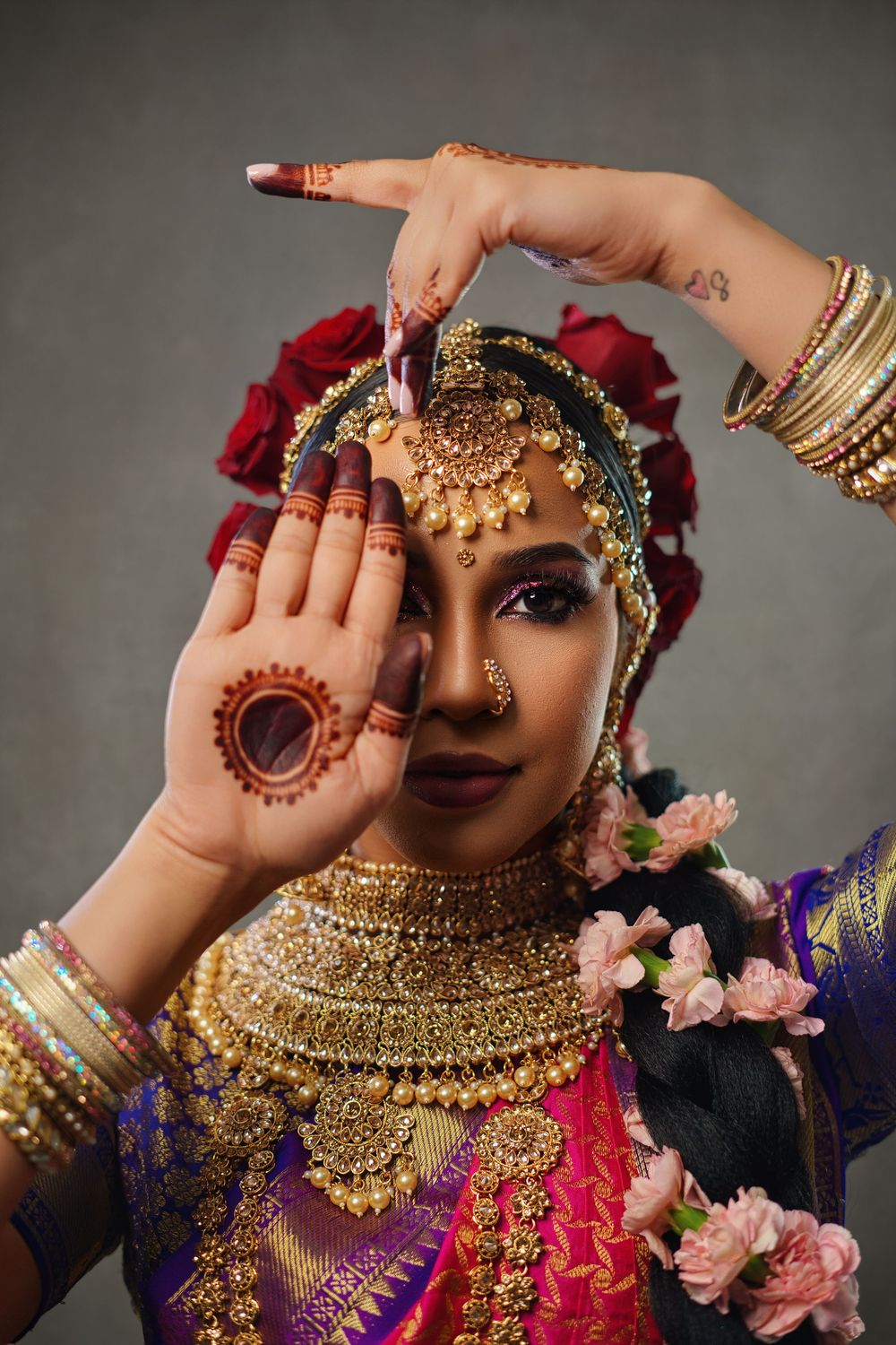 Close-up shots of traditional Indian bridal jewelry and decorative elements with pink flowers and colorful fabrics.