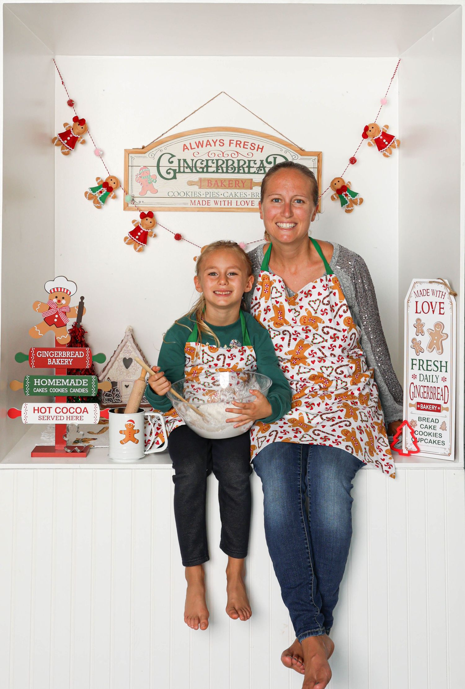 Gingerbread themed photo setup with festive signs and holiday decorations. Box photography session